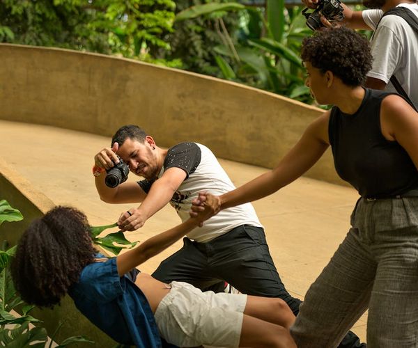 A diverse group of people smiling during a light yoga session.