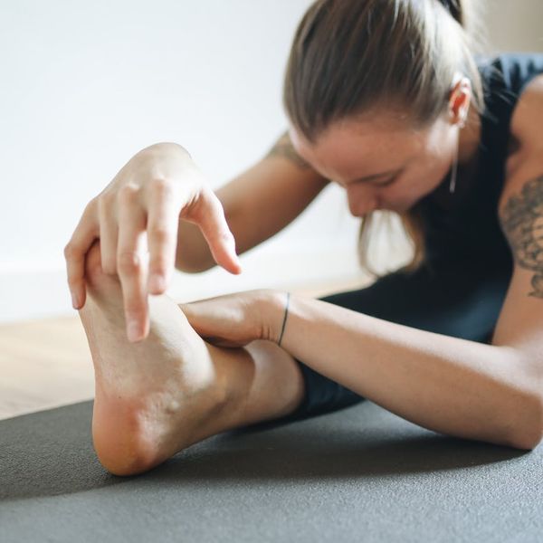 Person practicing a challenging yoga pose that requires balance and strength.